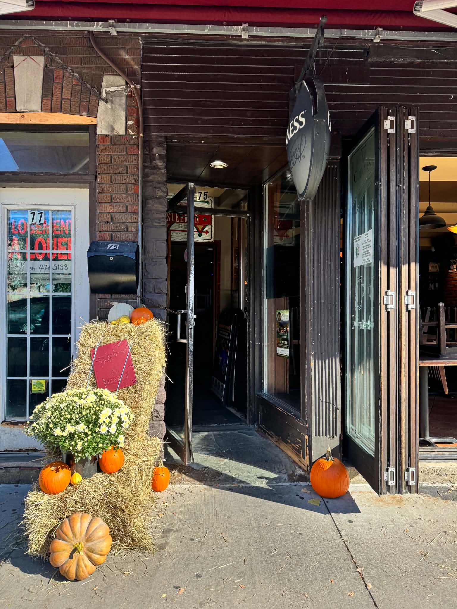 Waterfront entrance styled with flowering mums, ornamental kale, and white heirloom pumpkins in Sainte-Anne-de-Bellevue
